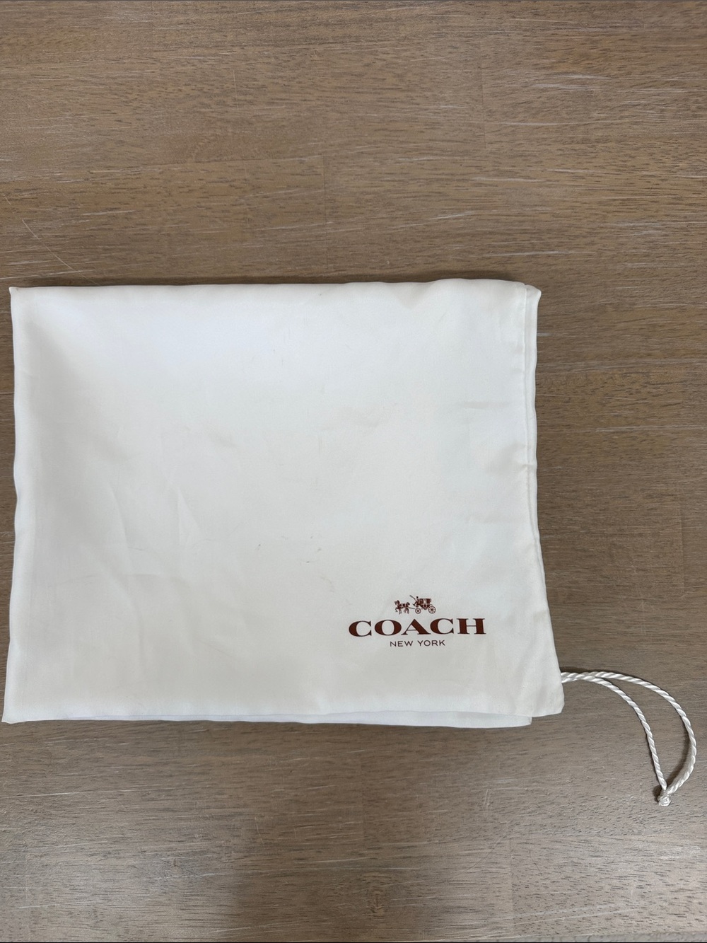 Coach 23” x 19” satin dust bag in white with brown lettering, GUC